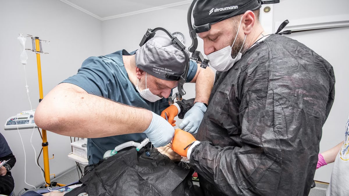 Two dental surgeons focus on a complex procedure in a modern clinic setting.